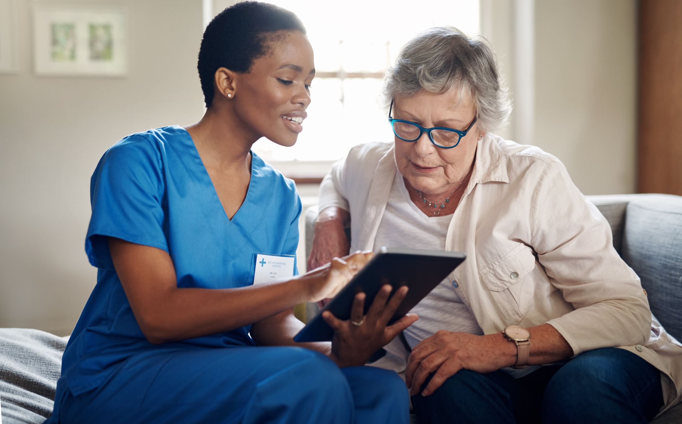 Nurse and patient reviewing treatment plan together on tablet